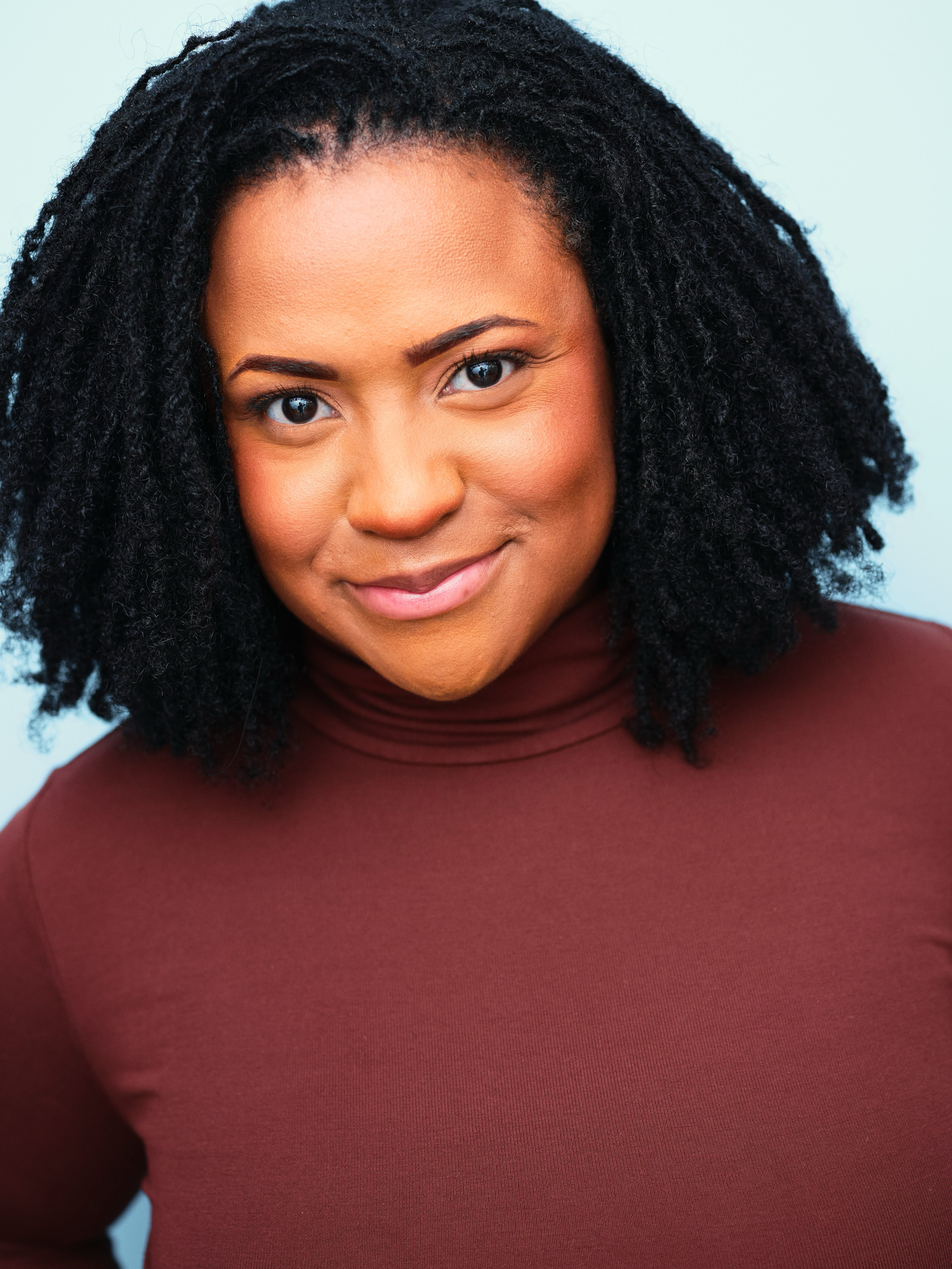 Ninti Chance Smiling Brown Turtleneck Headshot